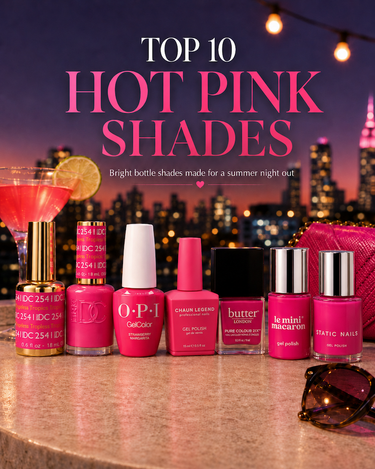 Top 10 hot pink nail polishes lined up on a marble bar with a pink cocktail and city skyline lights in the background.